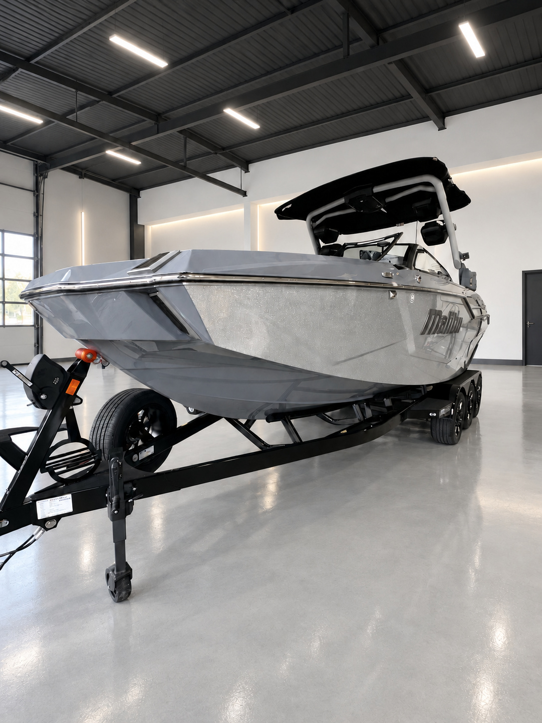 Malibu boat inside a clean marine detailing studio